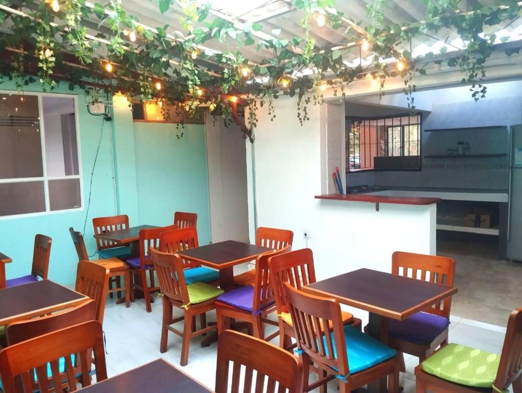 a room with tables and chairs and a piano at Serene Oasis in Pasto Cozy Guest Room with Private Bathroom in Pasto