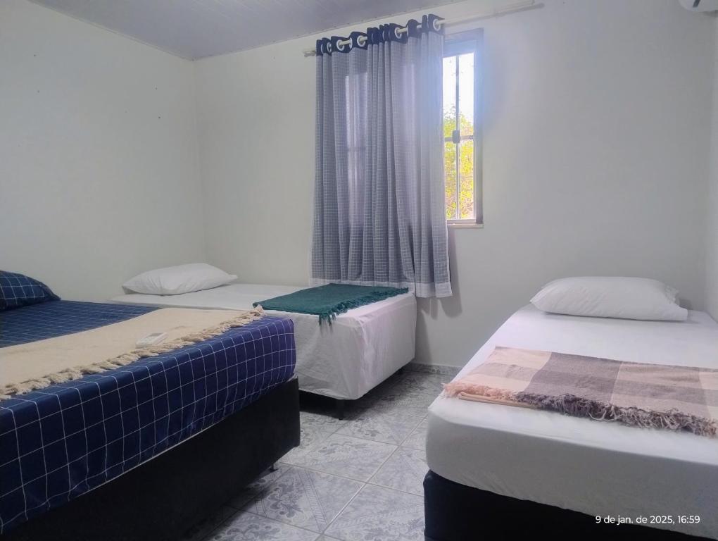Postel nebo postele na pokoji v ubytování hostel xamã