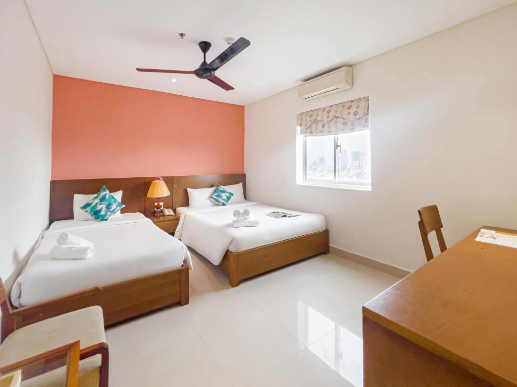 Voodi või voodid majutusasutuse Doha Central Bliss Danang Hotel by Haviland toas