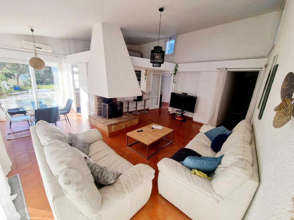 - un salon avec deux canapés blancs et une table dans l'établissement Jolie villa 4 chambres, à Martigues
