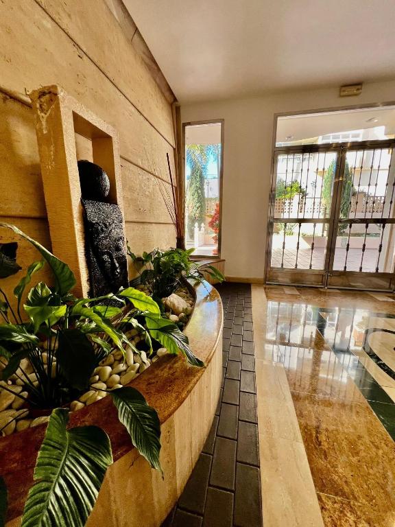 a large room with plants on a wall at 2 Bedroom Apartment in Puerto Marina in Benalmadena Costa