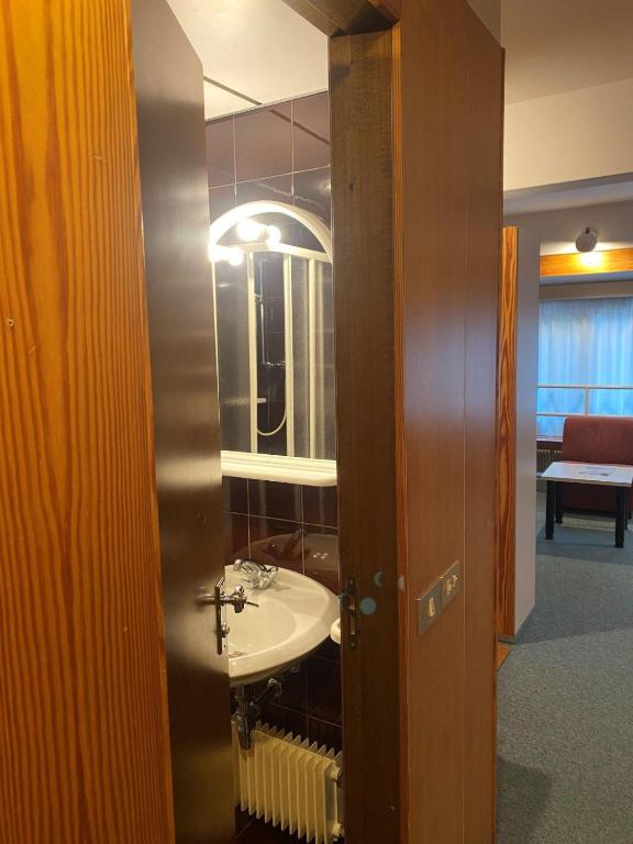 a bathroom with a sink and a mirror at Residence Solaria, Albarè, Marilleva 1400 in Marilleva
