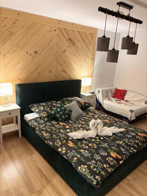 a bedroom with a bed with two stuffed animals on it at Apartamenty u Ptaszka in Zakopane