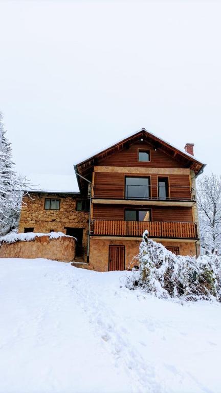 a log cabin with snow on the ground at Holiday apartement Sentjur in Šentjur