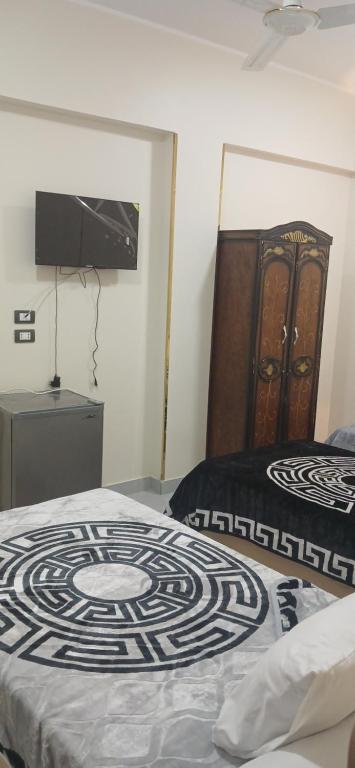 Postel nebo postele na pokoji v ubytování Gannet Al Yousef City Center