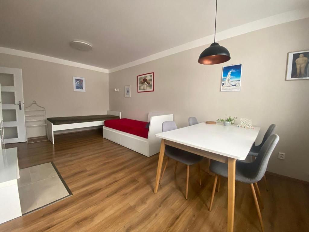 a living room with a table and a bed at Apartmán U Rybníčku in Loučná nad Desnou