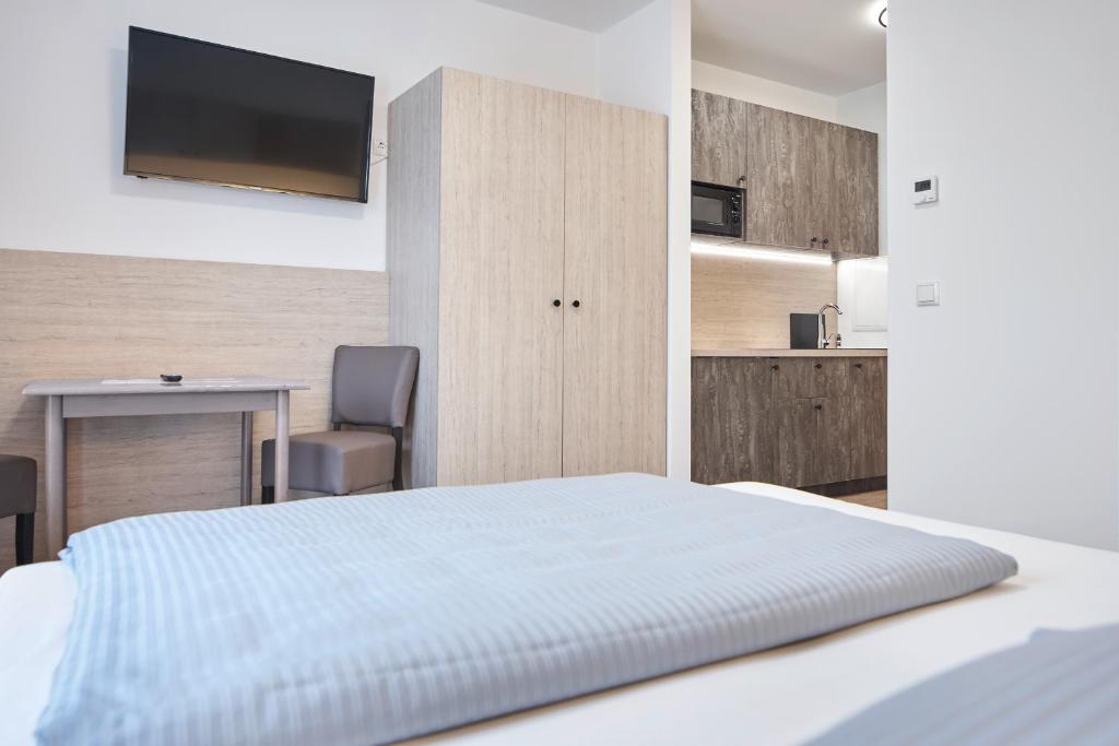 Postel nebo postele na pokoji v ubytování Bader Aparthotel
