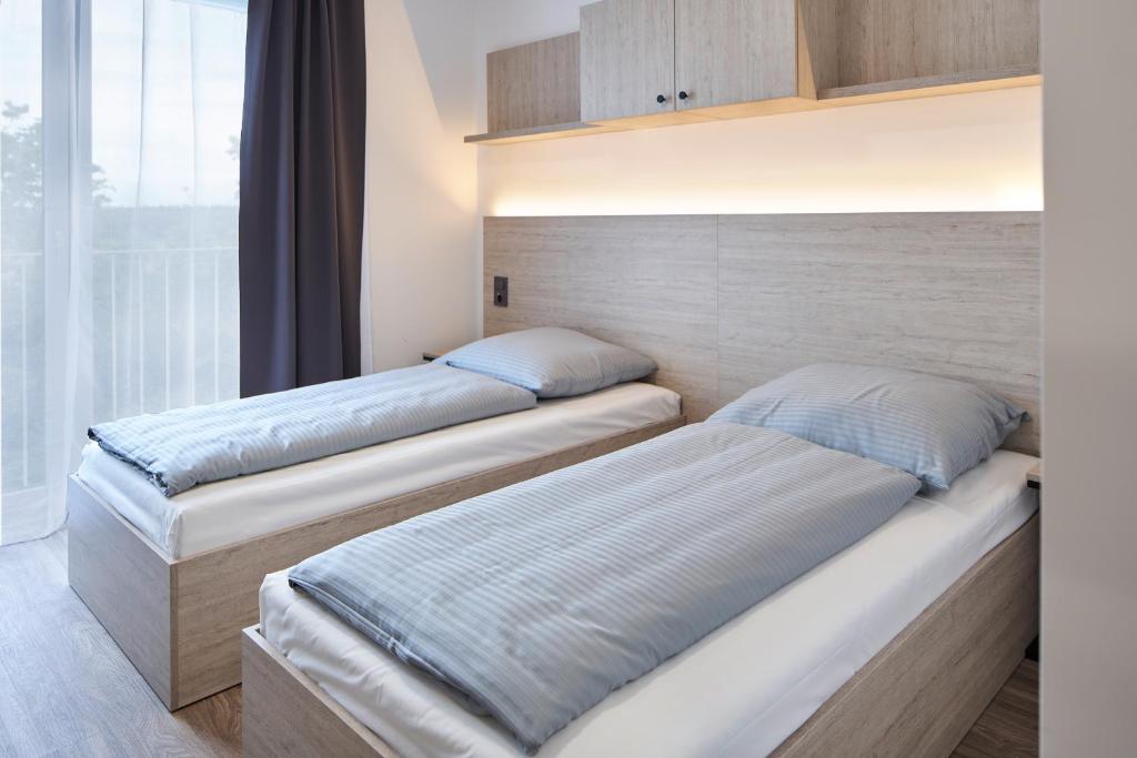 Postel nebo postele na pokoji v ubytování Bader Aparthotel