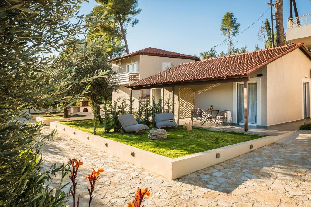 a house with a garden in front of it at Malibu Suites & Apartments in Argostoli