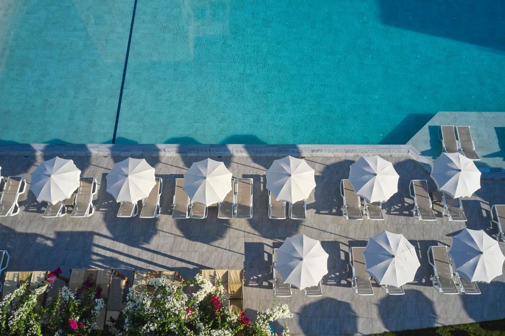 an overhead view of a pool with chairs and umbrellas at Atlantica Sungarden Park in Ayia Napa