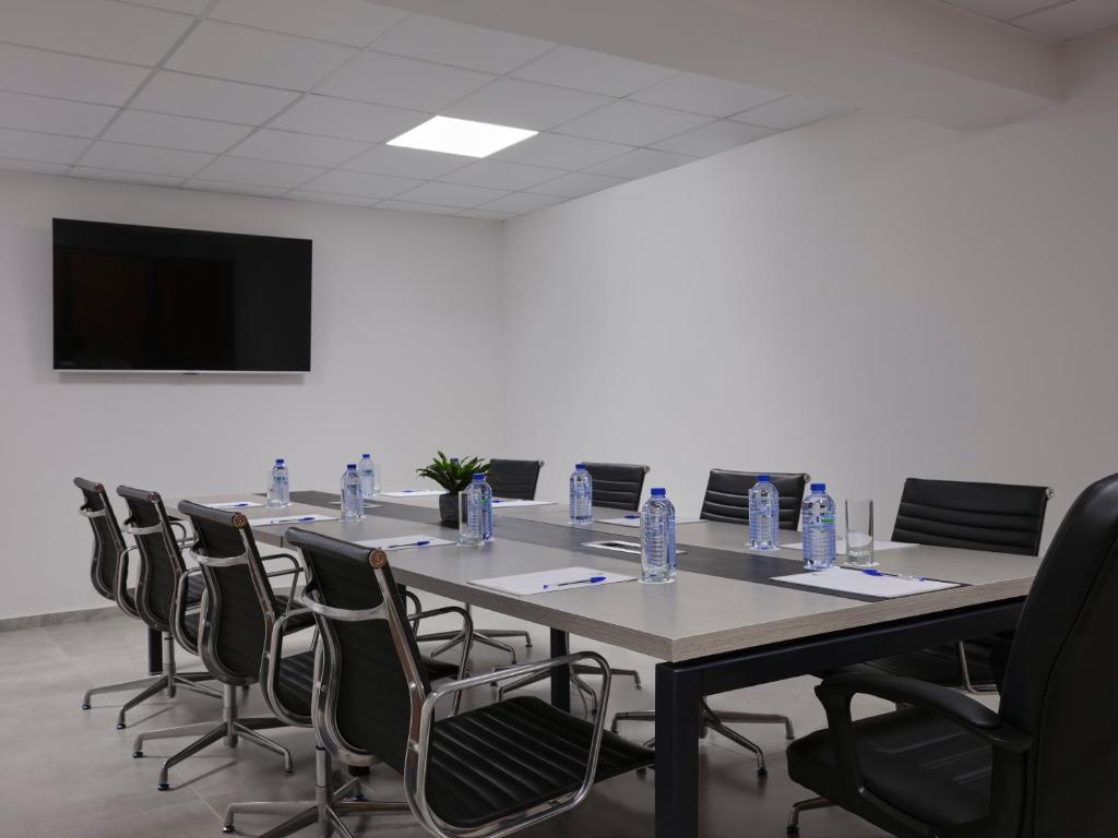 a conference room with a long table and chairs at Atlantica Sungarden Park in Ayia Napa