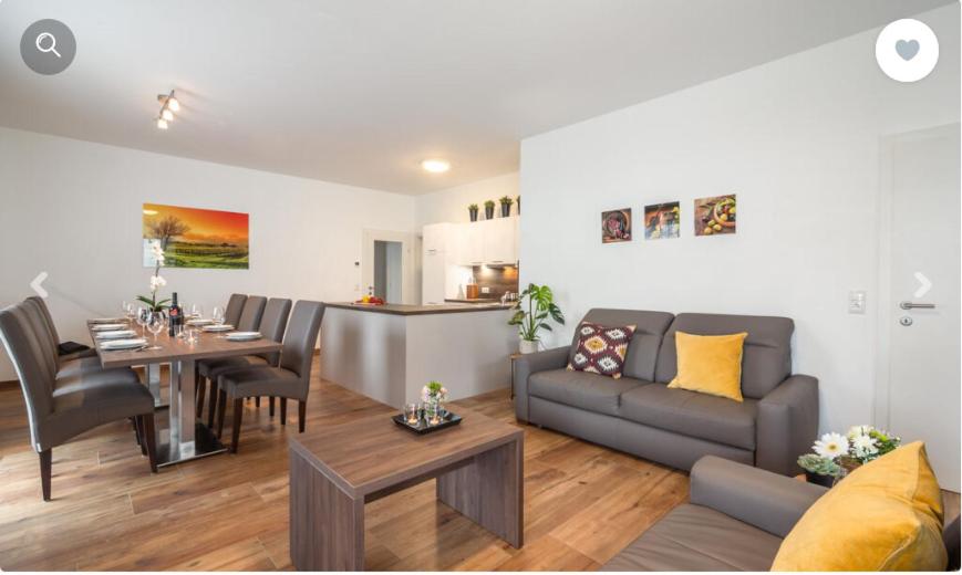a living room with a couch and a table at Stadtdomizil TOP 10 in Schladming