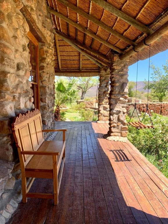 a wooden porch with a bench on a wooden deck at Green Silence in McGregor