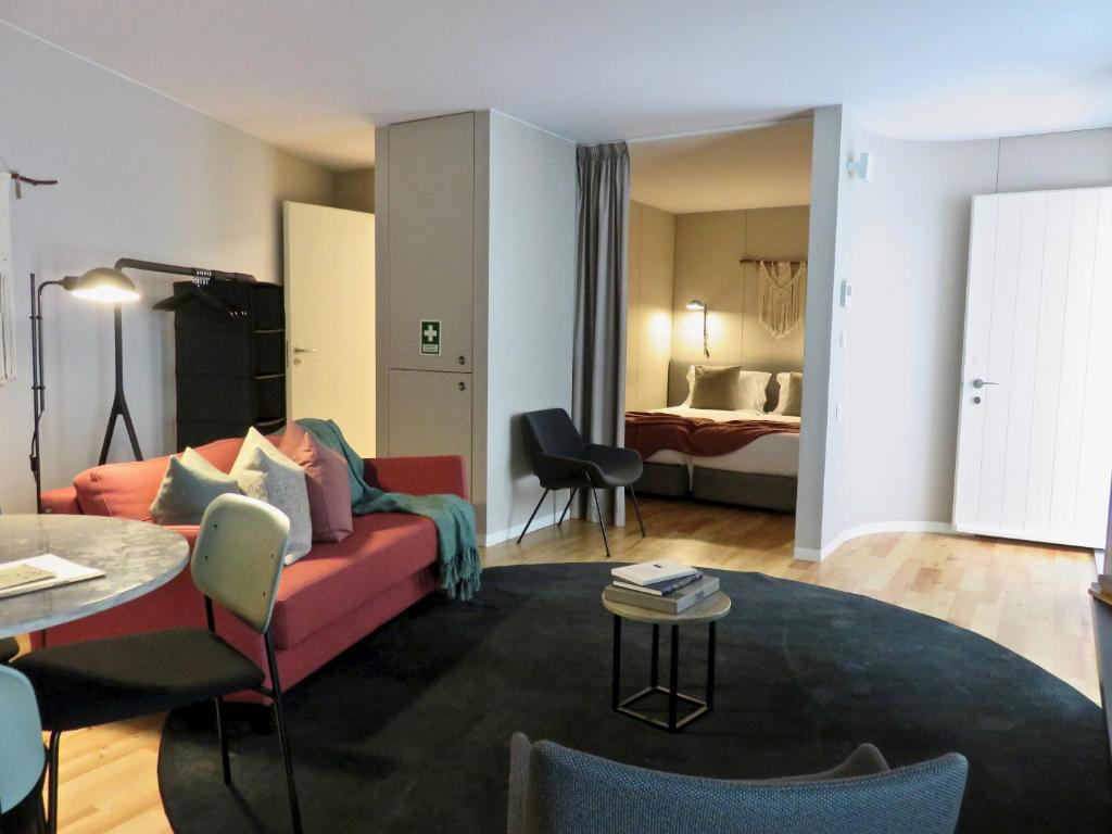 a living room with a couch and a room with a bed at Oporto Serviced Apartments - Miragaia II in Porto