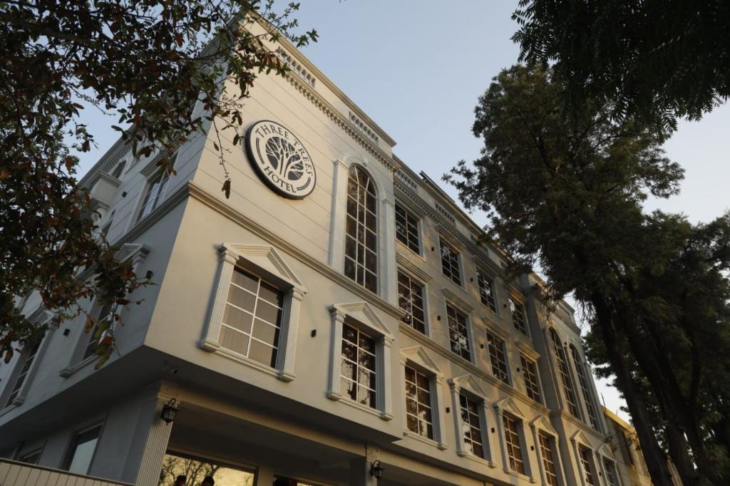 a building with a clock on the side of it at THREE TREE Signature Hotel - G7 Markaz Islamabad in Islamabad