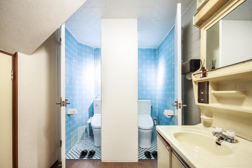 a bathroom with a toilet and a sink at Yadoya Hiraiwa private ryokan in Kyoto