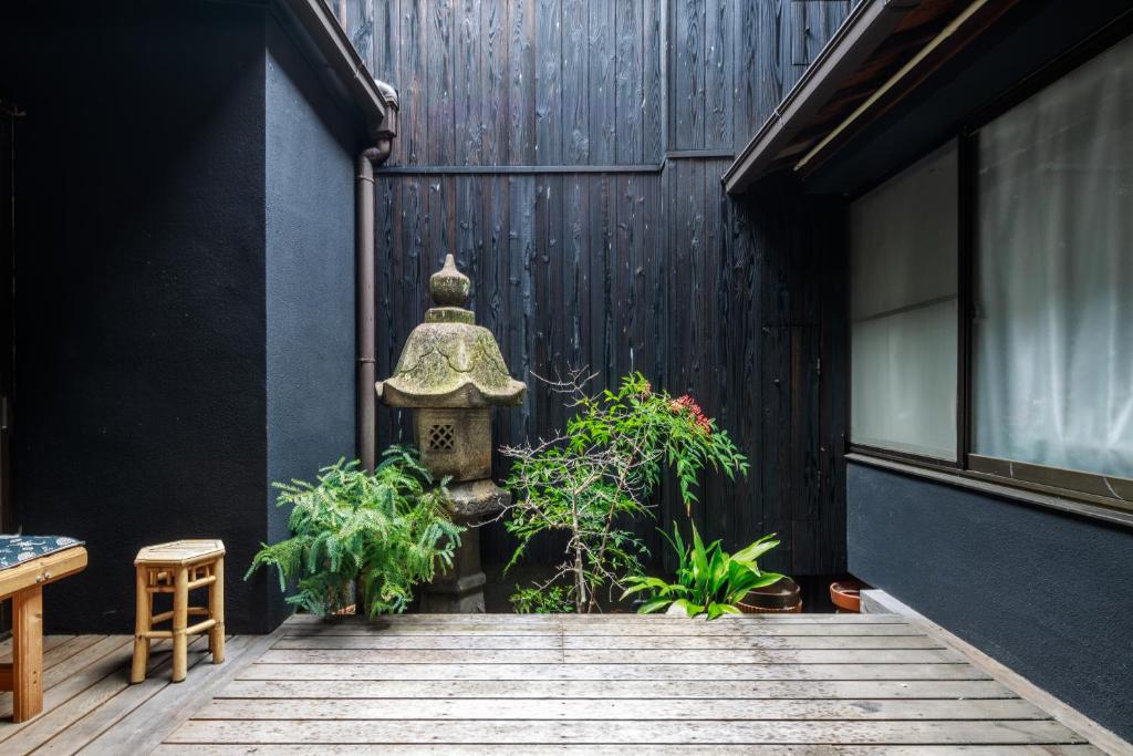 a courtyard with a fire hydrant and some plants at Yadoya Hiraiwa private ryokan in Kyoto