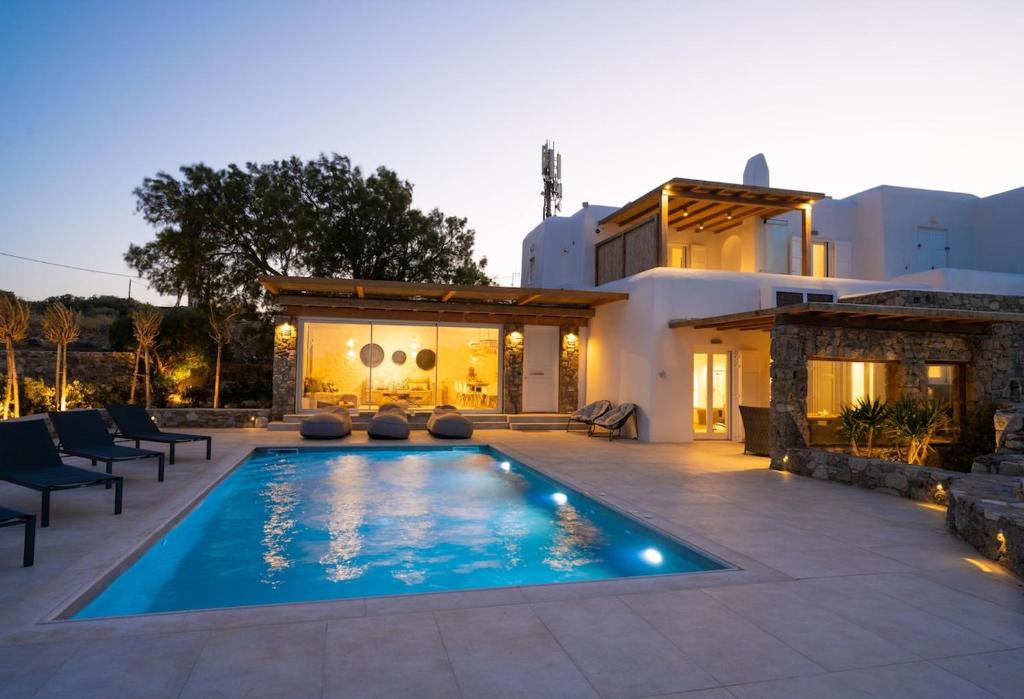 a swimming pool in front of a house at Ambiente Villas 3Βd-Agios Ioannis in Agios Ioannis Mykonos