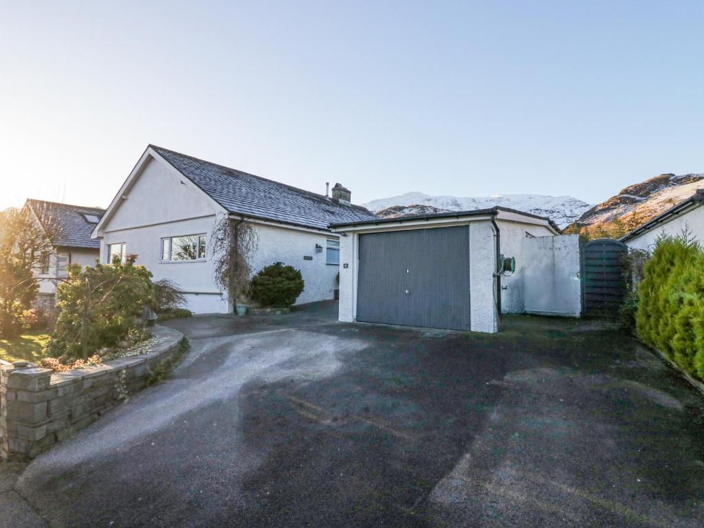 a house with a garage and a driveway at Hazelodge in Coniston