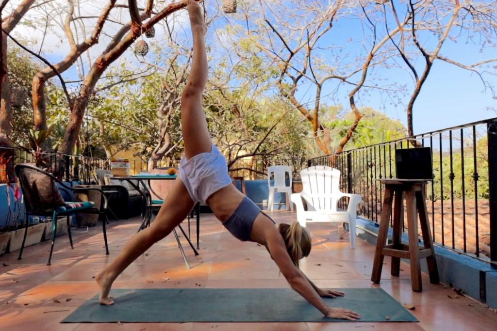 a woman doing a handstand on a yoga mat at Stunning 2BR, with outdoor living space and ocean view in Sayulita