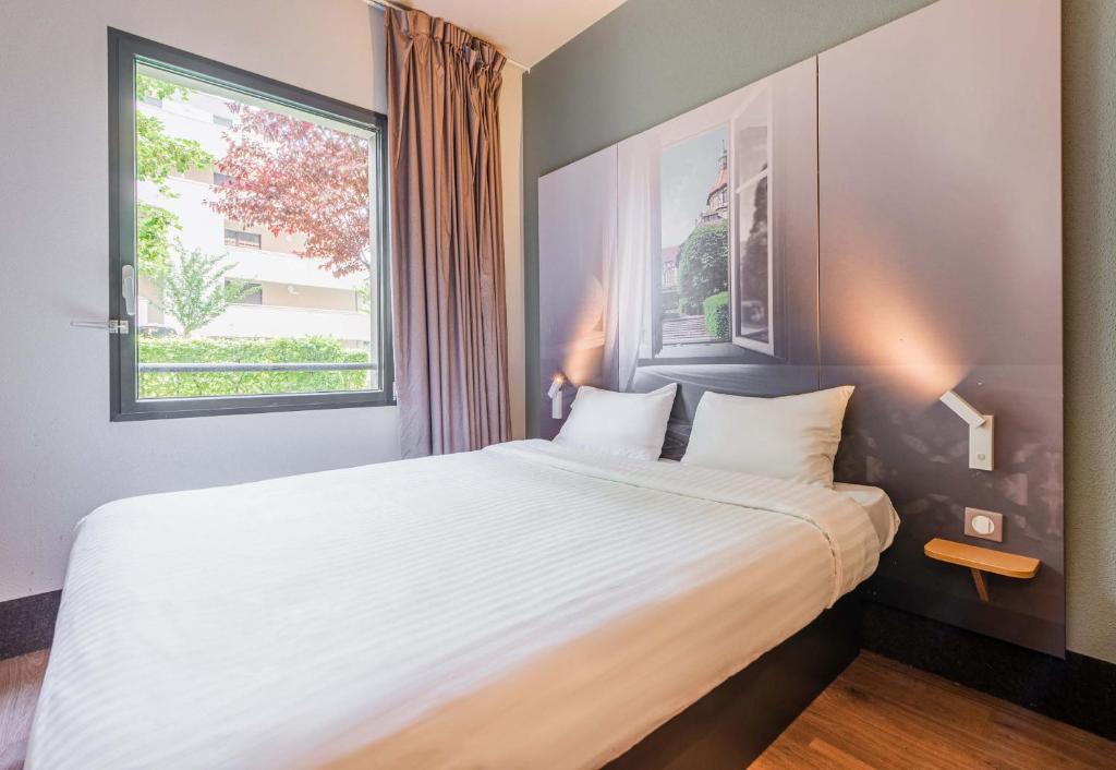 Postel nebo postele na pokoji v ubytování B&B HOTEL Mulhouse Centre
