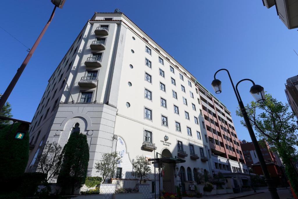 a white building with balconies on the side of it at Hotel Monterey Nagasaki in Nagasaki