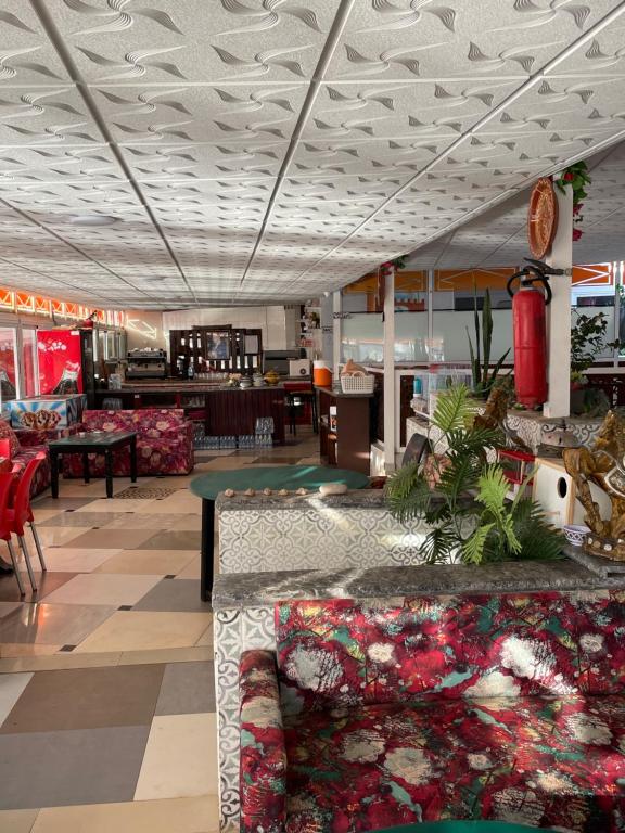 a lobby of a store with tables and chairs at Au soleil couchant in Mirleft