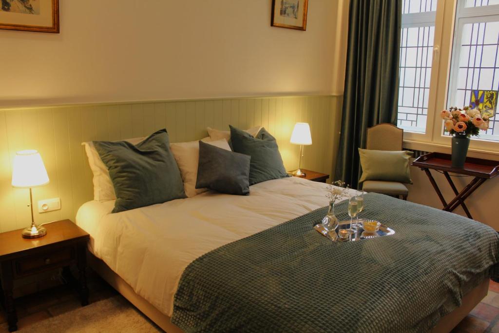 a bedroom with a large bed with a tray on it at 't Kabinet in Blankenberge
