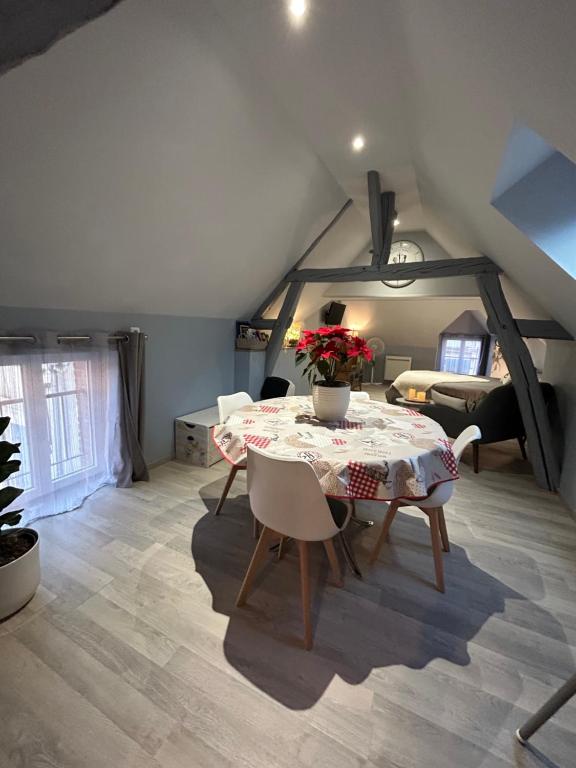 a dining room with a table and chairs in a attic at Studio centre ville in Romorantin