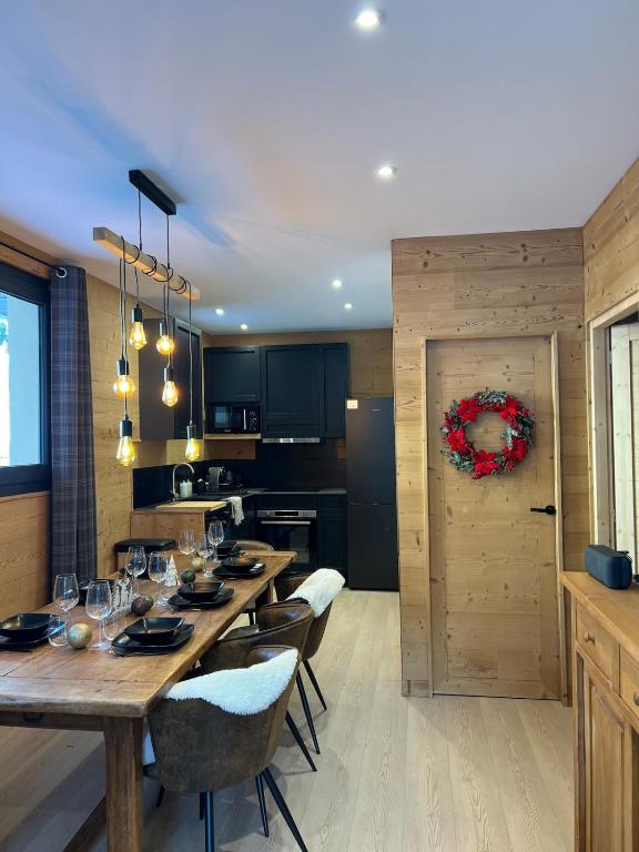 a kitchen with a long wooden table and chairs at La Foux d 'Allos centre station T4, 7 pers in La Foux