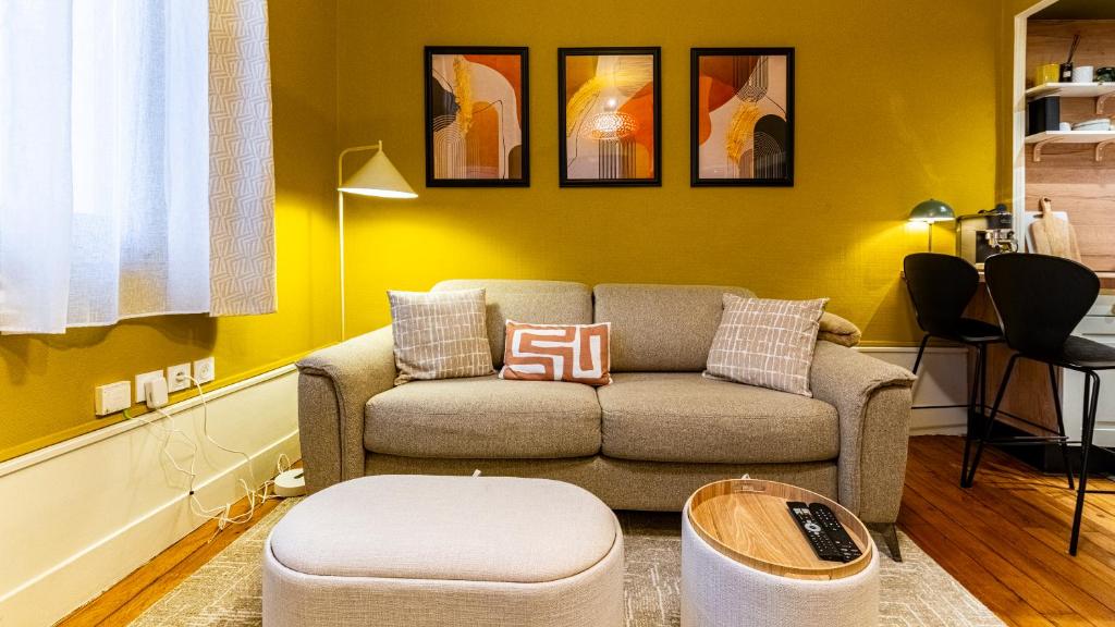 un salon avec un canapé et une table dans l'établissement La belle Jeannine - T2 40 m2 - Calme, central, haut de gamme, tout équipé, à Dijon