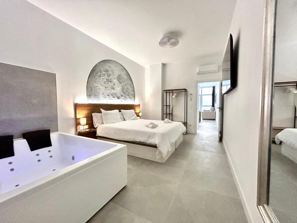 a bedroom with a large bed and a bath tub at Valencia Getaway - Jacuzzi, Space & Comfort in Valencia
