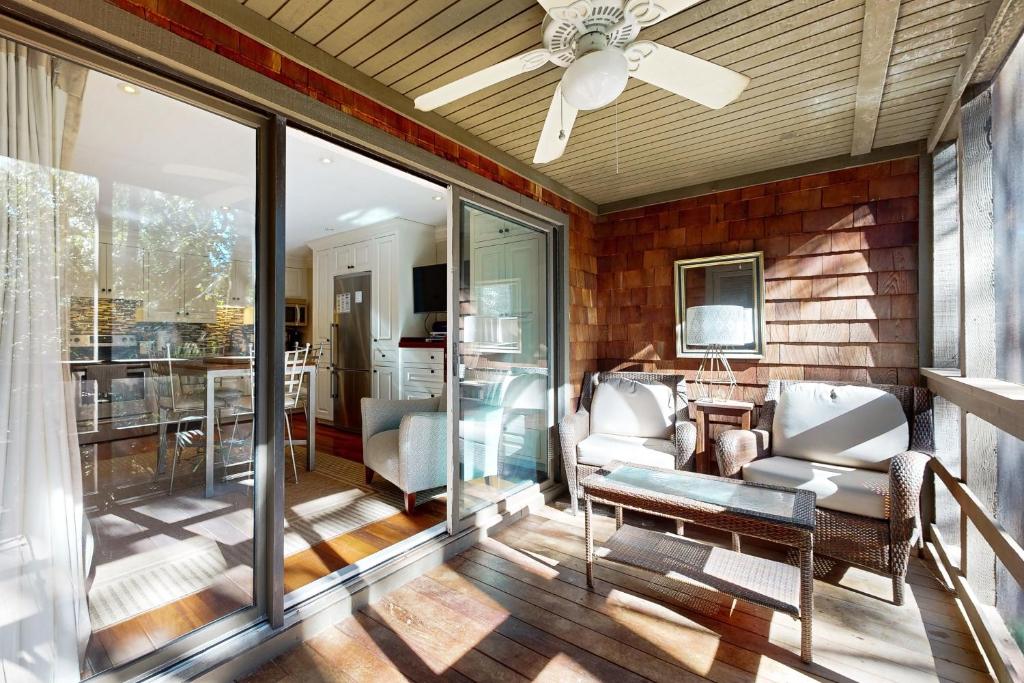 a screened porch with glass doors and a ceiling fan at Mariner's Watch 4236 in Kiawah Island