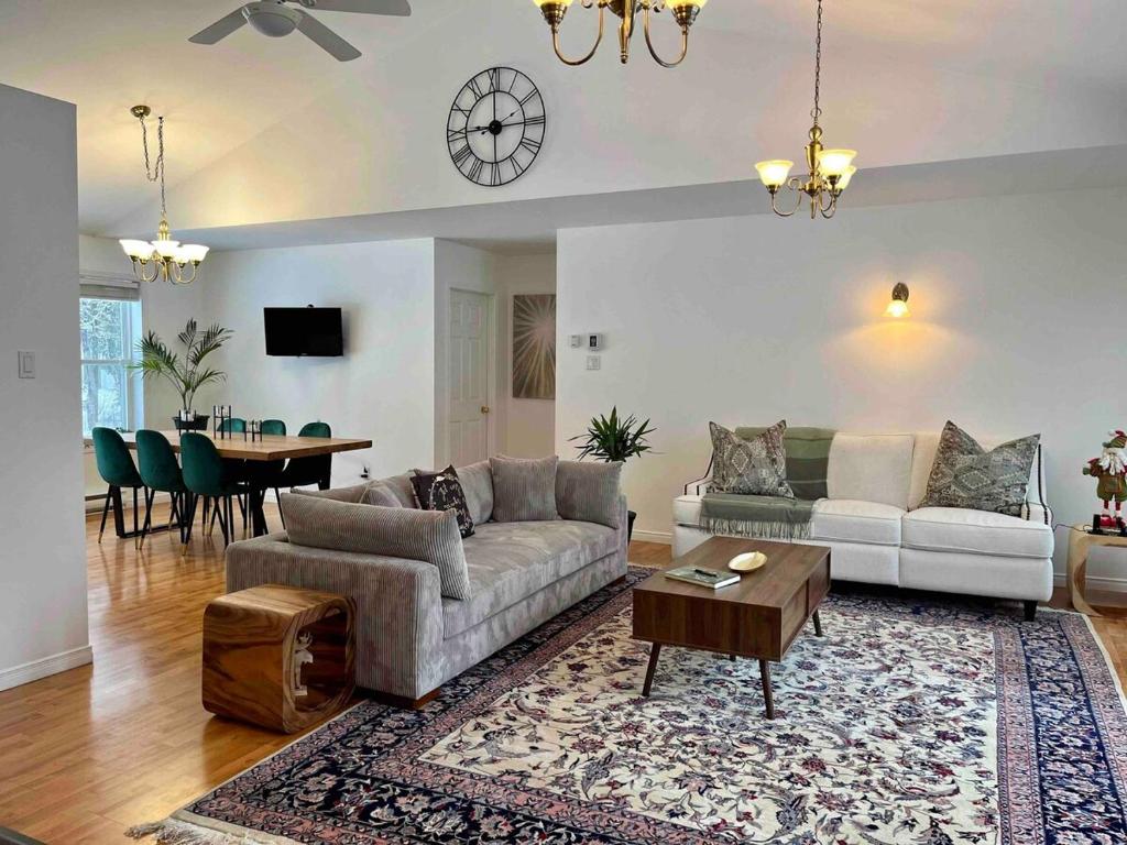 una sala de estar con un sofá y una mesa en Le 1717 Lakeside cottage, en Sainte-Lucie-de-Doncaster