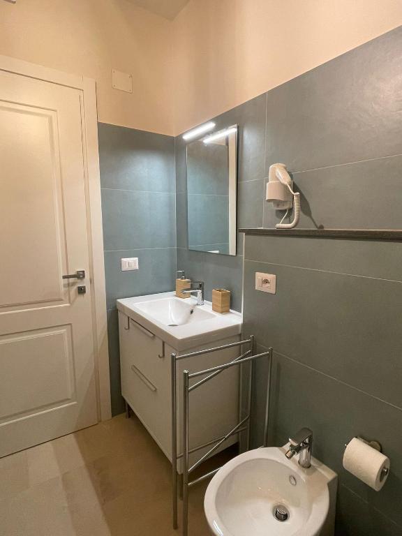 a bathroom with a sink and a toilet at Castello D'Alcontres Guest House 3 stelle in Nizza di Sicilia