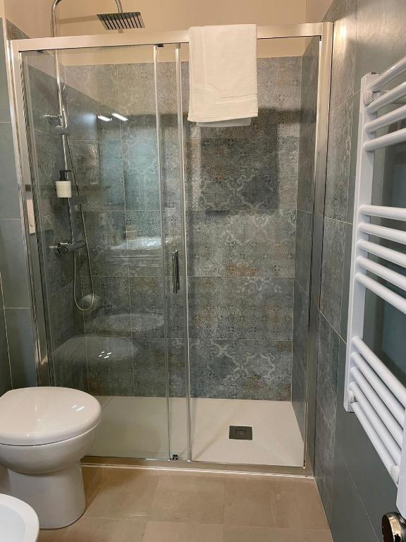 a shower stall in a bathroom with a toilet at Castello D'Alcontres Guest House 3 stelle in Nizza di Sicilia