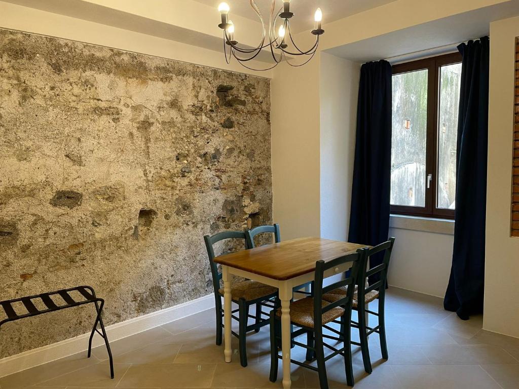 a dining room with a wooden table and chairs at Castello D'Alcontres Guest House 3 stelle in Nizza di Sicilia