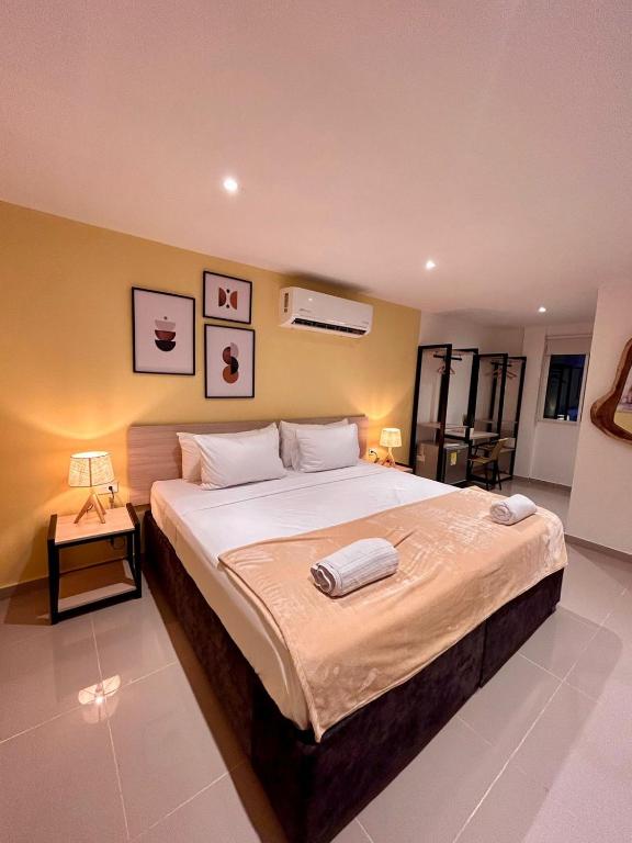 a bedroom with a large bed with two towels on it at Hotel Sol Caribe Cartagena in Cartagena de Indias