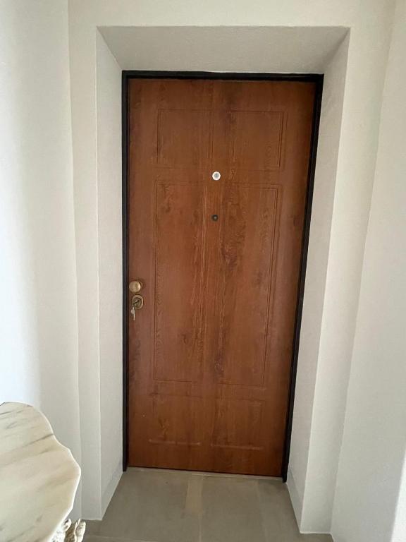 a brown door in a white room with at Castello D'Alcontres Guest House 3 stelle in Nizza di Sicilia