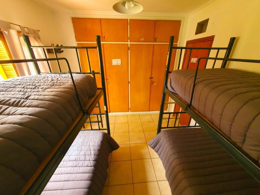 Postel nebo postele na pokoji v ubytování Hostel Punto Patagónico Neuquén