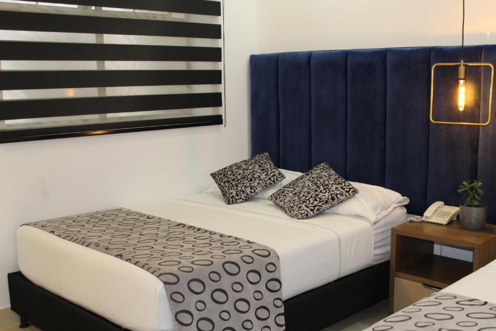 Postel nebo postele na pokoji v ubytování Hotel Merlott Lleras