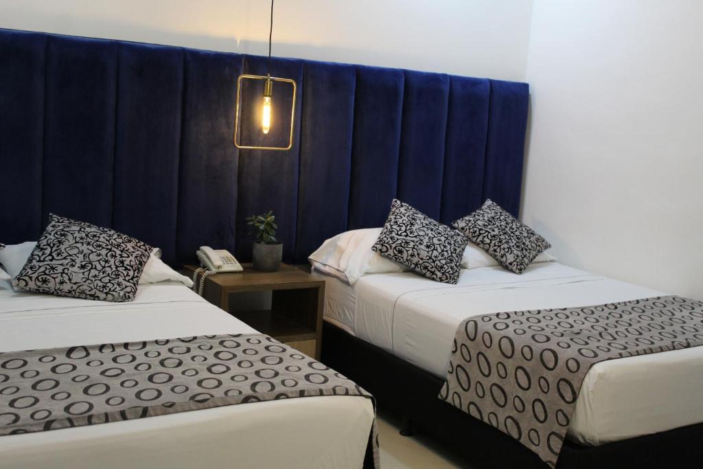 Postel nebo postele na pokoji v ubytování Hotel Merlott Lleras