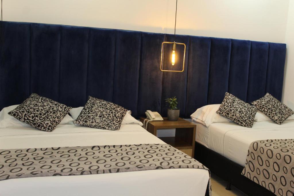 Postel nebo postele na pokoji v ubytování Hotel Merlott Lleras