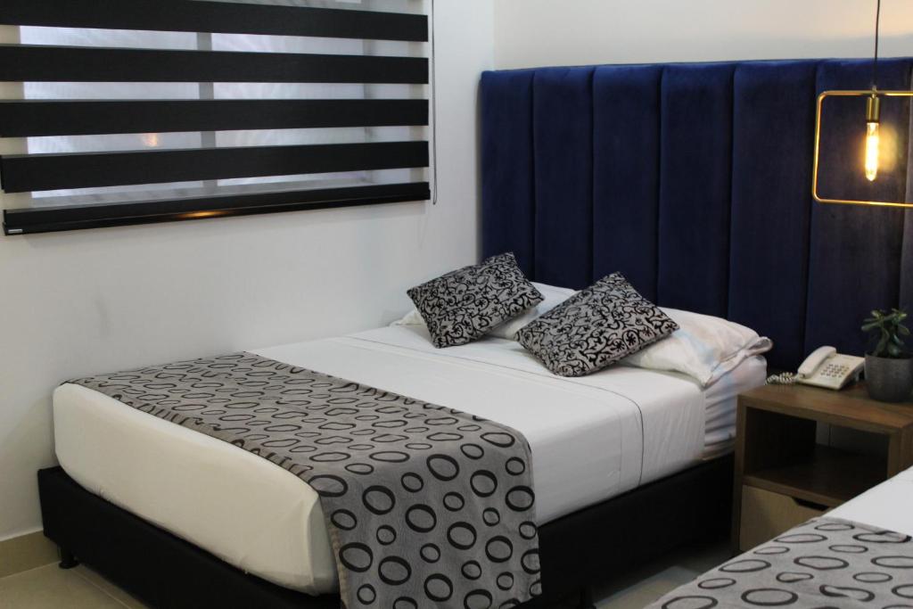 Postel nebo postele na pokoji v ubytování Hotel Merlott Lleras