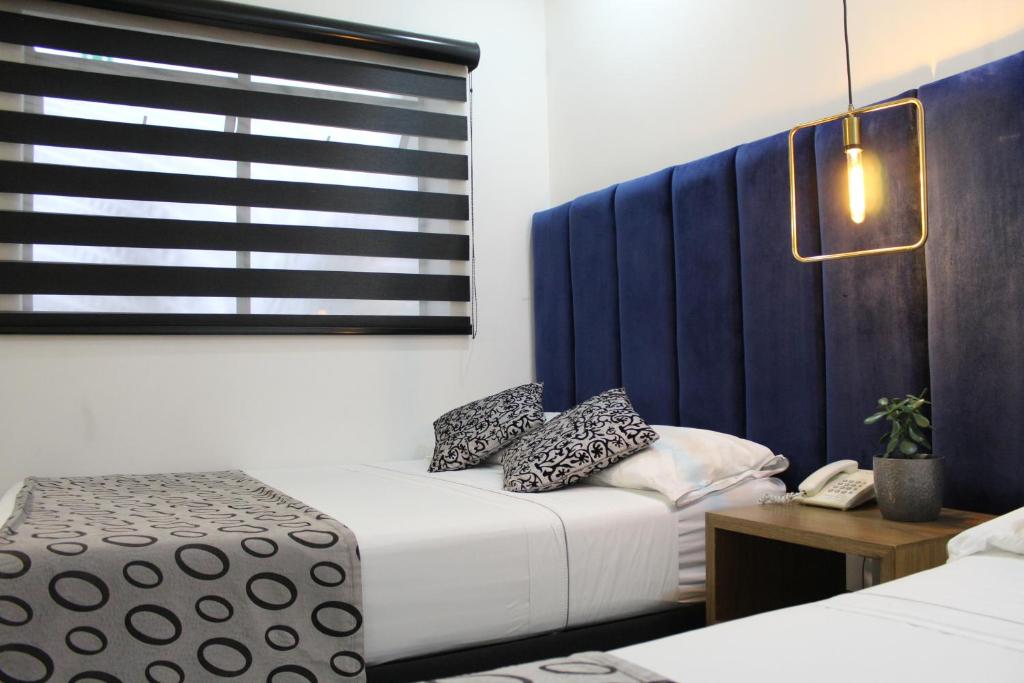 Postel nebo postele na pokoji v ubytování Hotel Merlott Lleras