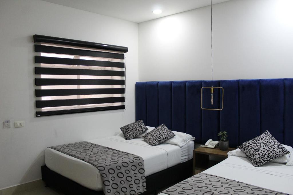 Postel nebo postele na pokoji v ubytování Hotel Merlott Lleras