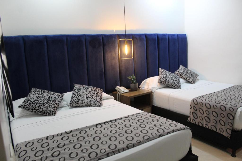 Postel nebo postele na pokoji v ubytování Hotel Merlott Lleras