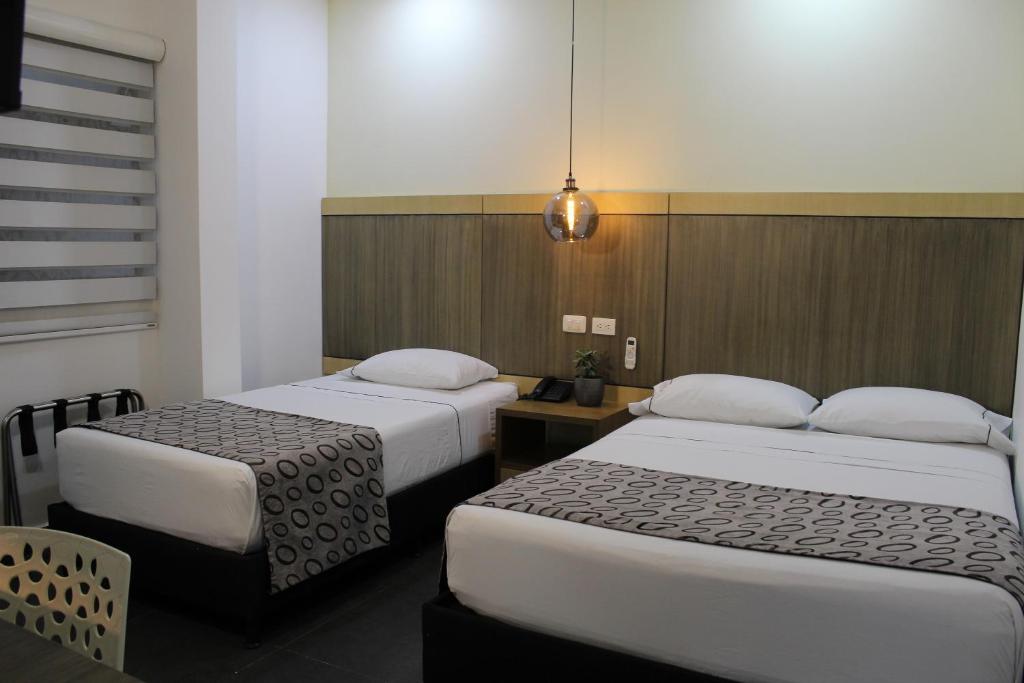 Postel nebo postele na pokoji v ubytování Hotel Merlott Lleras
