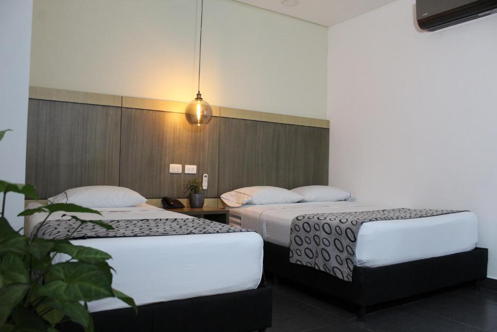 Postel nebo postele na pokoji v ubytování Hotel Merlott Lleras