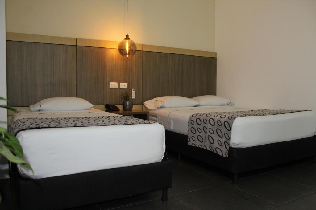 Postel nebo postele na pokoji v ubytování Hotel Merlott Lleras